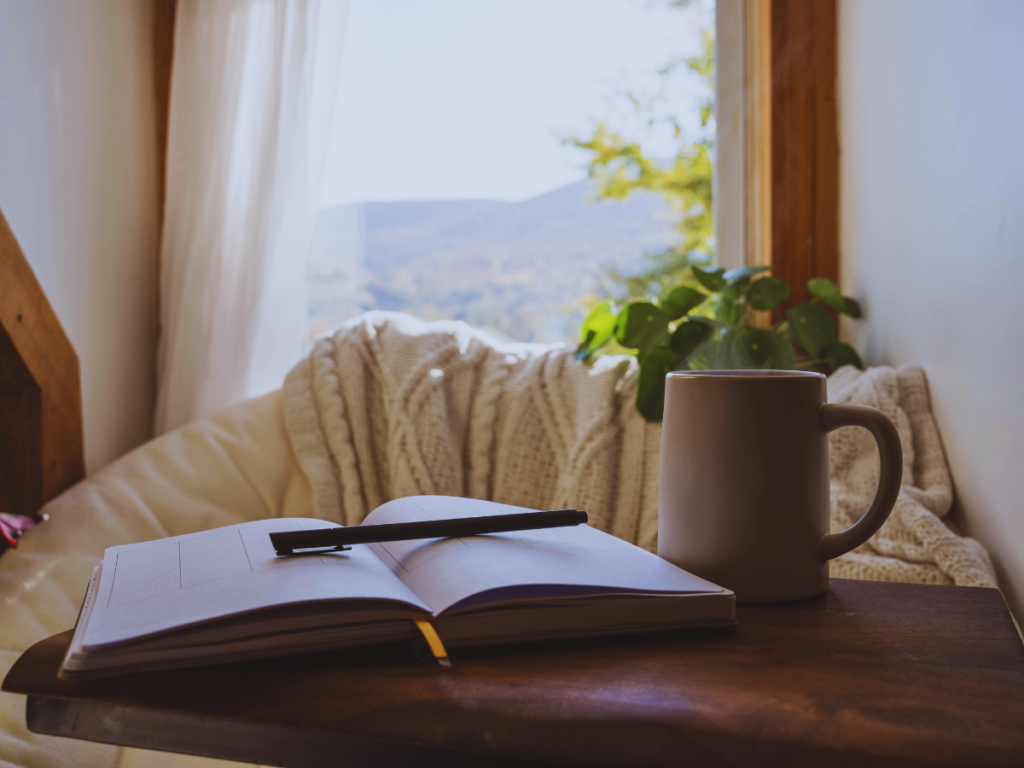 Open journal for mindfulness and coffee mug